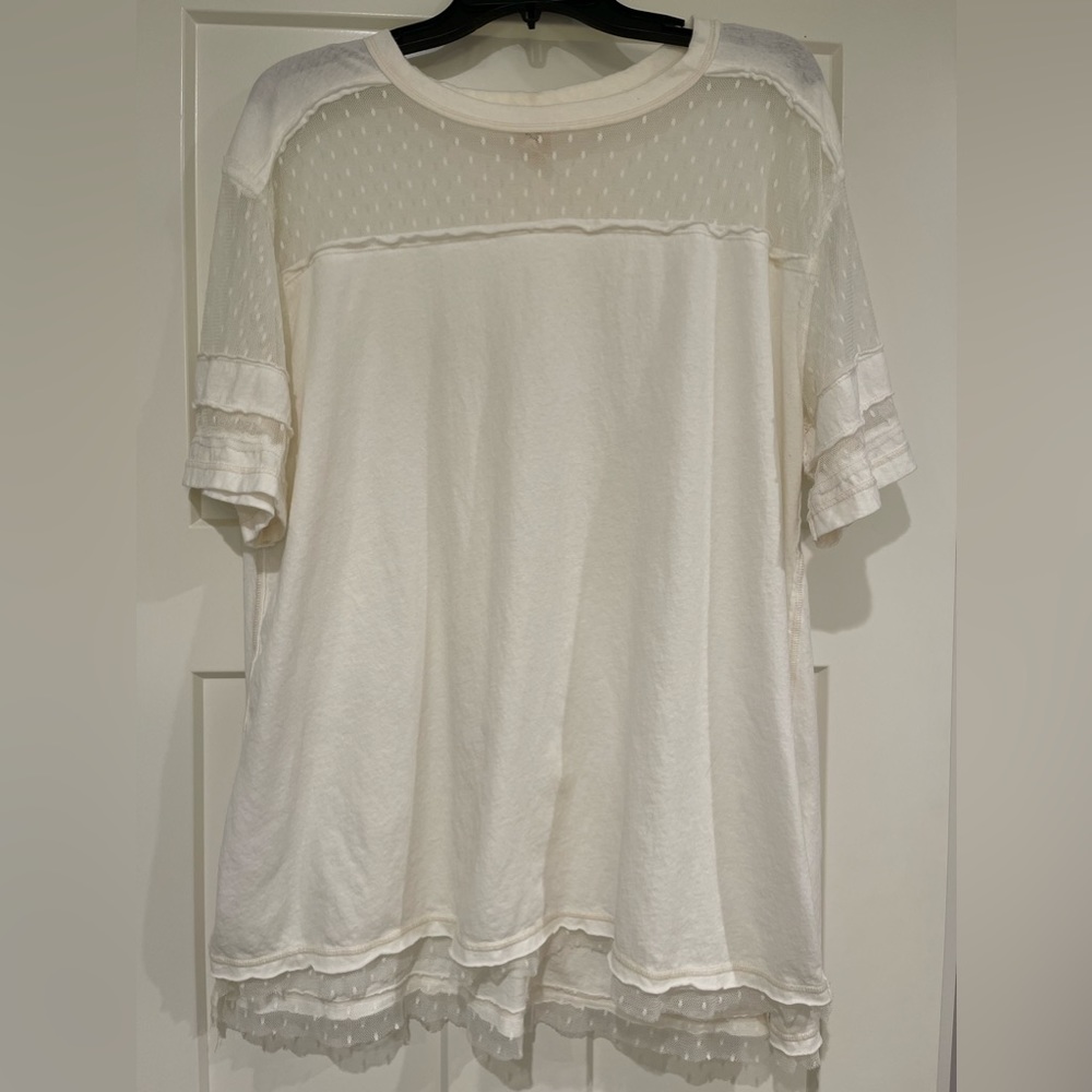 White t-shirt with lace accents. Oversized fit.